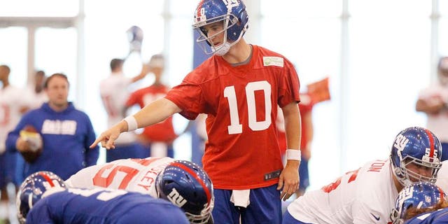 Jun 12, 2014; East Rutherford, NJ, USA; New York Giants quarterback Eli Manning (10) calls a play during New York Giants minicamp at the Quest Diagnostics Training Center. William Perlman/The Star-Ledger-USA TODAY Sports