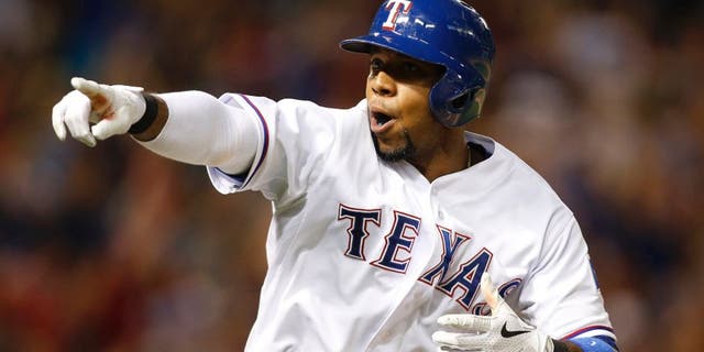 Jun 12, 2015; Arlington, TX, USA; Texas Rangers shortstop Elvis Andrus (1) points to the dugout after hitting a two run home run in the seventh inning against the Minnesota Twins at Globe Life Park in Arlington. Texas won 6-2. Mandatory Credit: Tim Heitman-USA TODAY Sports