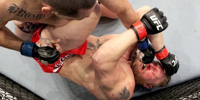 ANAHEIM, CA - OCTOBER 23: (L-R) Cain Velasquez connects on a left to the face of Brock Lesnar in the first round during the heavyweight title bout during UFC 121 on October 23, 2010 in Anaheim, California. Velasquez defeated Lenar by first round TKO to become the new UFC heavyweight champion. (Photo by Josh Hedges/Zuffa LLC/Zuffa LLC via Getty Images) *** Local Caption *** Brock Lesnar;Cain Velasquez