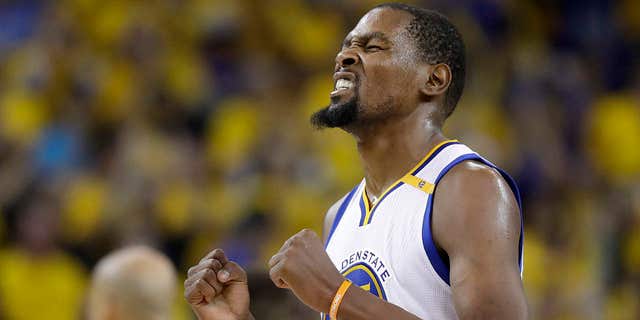 Golden State Warriors forward Kevin Durant reacts after scoring against the Cleveland Cavaliers during the second half of Game 5 of basketball's NBA Finals in Oakland, Calif., Monday, June 12, 2017.