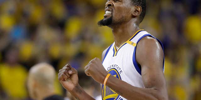 Golden State Warriors forward Kevin Durant reacts after scoring against the Cleveland Cavaliers during the second half of Game 5 of basketball's NBA Finals in Oakland, Calif., Monday, June 12, 2017.