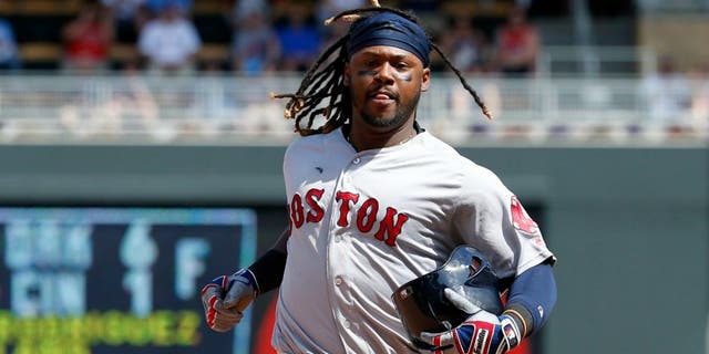 Boston Red Sox's Hanley Ramirez carries his batting helmet while running to third base on a throwing error by Minnesota Twins catcher Juan Centeno during the eighth inning of a baseball game in Minneapolis, Sunday, June 12, 2016. The Twins won 7-4. (AP Photo/Ann Heisenfelt)