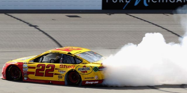 BROOKLYN, MI - JUNE 12: Joey Logano, driver of the #22 Shell Pennzoil Ford, celebrates with a burnout after winning the NASCAR Sprint Cup Series FireKeepers Casino 400 at Michigan International Speedway on June 12, 2016 in Brooklyn, Michigan. (Photo by Kena Krutsinger/Getty Images )