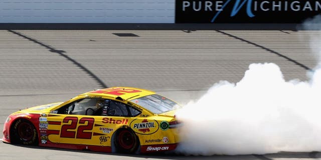 BROOKLYN, MI - JUNE 12: Joey Logano, driver of the #22 Shell Pennzoil Ford, celebrates with a burnout after winning the NASCAR Sprint Cup Series FireKeepers Casino 400 at Michigan International Speedway on June 12, 2016 in Brooklyn, Michigan. (Photo by Kena Krutsinger/Getty Images )