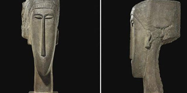 The stone sculpture 'Tete' by artist Amedeo Modigliani has sold for a record $52.8 million at auction in Paris.