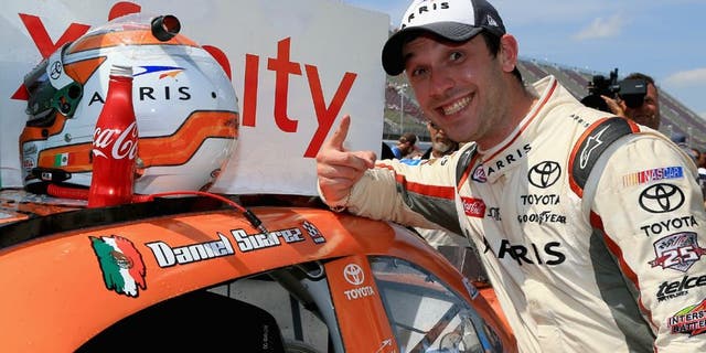 BROOKLYN, MI - JUNE 11: Daniel Suarez, driver of the #19 ARRIS Toyota, places a winner's sticker decal on his car after winning the NASCAR XFINITY Series Menards 250 at Michigan International Speedway on June 11, 2016 in Brooklyn, Michigan. (Photo by Daniel Shirey/NASCAR via Getty Images)