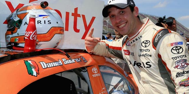 BROOKLYN, MI - JUNE 11: Daniel Suarez, driver of the #19 ARRIS Toyota, places a winner's sticker decal on his car after winning the NASCAR XFINITY Series Menards 250 at Michigan International Speedway on June 11, 2016 in Brooklyn, Michigan. (Photo by Daniel Shirey/NASCAR via Getty Images)