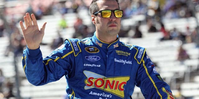 FORT WORTH, TX - NOVEMBER 08: Sam Hornish Jr., driver of the #9 Sonic Ford, greets fans from a parade vehicle during pre-race ceremonies for the NASCAR Sprint Cup Series AAA Texas 500 at Texas Motor Speedway on November 8, 2015 in Fort Worth, Texas. (Photo by Tim Bradbury/Getty Images for Texas Motor Speedway)