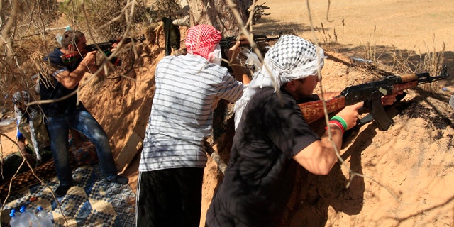 June 15: Rebel fighters fire towards pro-Muammar al-Qaddafi forces at the front line of Dafniya, about 25 miles west of Misrata, Libya.