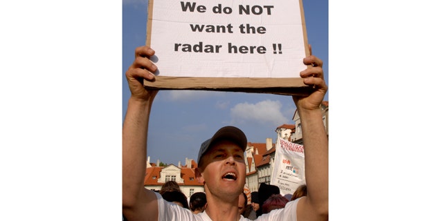 This June 4, 2007, file photo shows a Czech protester holding a banner against a possible radar base during a demonstration in Prague, Czech Republic.