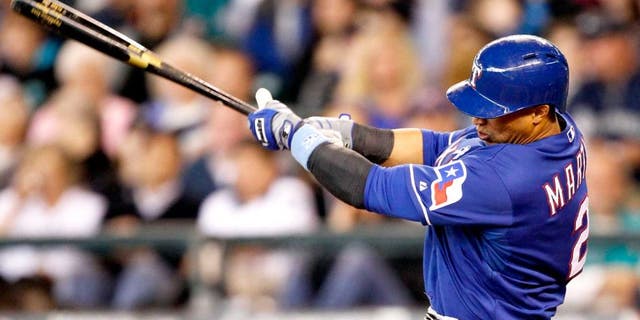 Jun 15, 2014; Seattle, WA, USA; Texas Rangers center fielder Leonys Martin (2) singles against the Seattle Mariners during the third inning at Safeco Field. Mandatory Credit: Joe Nicholson-USA TODAY Sports