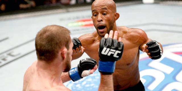 VANCOUVER, BC - JUNE 14: (R-L) Demtrious 'Mighty Mouse' Johnson punches Ali Bagautinov in their UFC flyweight championship bout at Rogers Arena on June 14, 2014 in Vancouver, Canada. (Photo by Josh Hedges/Zuffa LLC/Zuffa LLC via Getty Images)