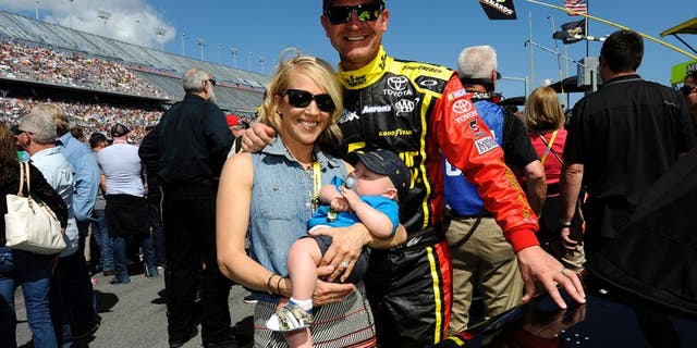 DAYTONA BEACH, FL - FEBRUARY 22: Clint Bowyer, driver of the #15 5-hour ENERGY Toyota, wife Lorra and son Cash Aaron pose for a picture on the grid prior to the NASCAR Sprint Cup Series 57th Annual Daytona 500 at Daytona International Speedway on February 22, 2015 in Daytona Beach, Florida. (Photo by Jared C. Tilton/Getty Images)