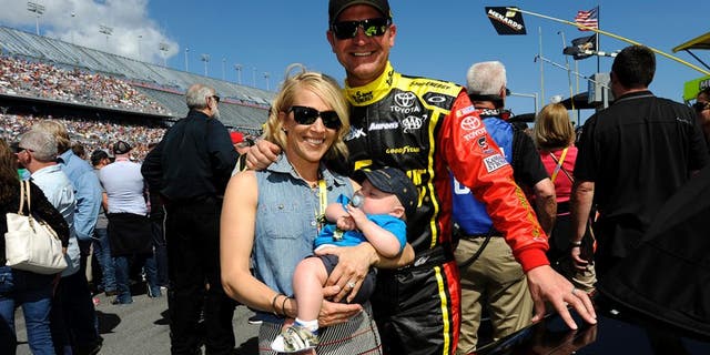 DAYTONA BEACH, FL - FEBRUARY 22: Clint Bowyer, driver of the #15 5-hour ENERGY Toyota, wife Lorra and son Cash Aaron pose for a picture on the grid prior to the NASCAR Sprint Cup Series 57th Annual Daytona 500 at Daytona International Speedway on February 22, 2015 in Daytona Beach, Florida. (Photo by Jared C. Tilton/Getty Images)