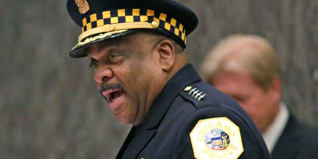 FILE - In this April 13, 2016, file photo, Eddie Johnson, left, speaks after being sworn in as the new Chicago police superintendent in Chicago.