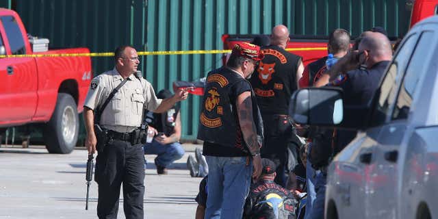 FILE - In this May 17, 2015, file photo, authorities investigate a shooting in the parking lot of the Twin Peaks restaurant in Waco, Texas.