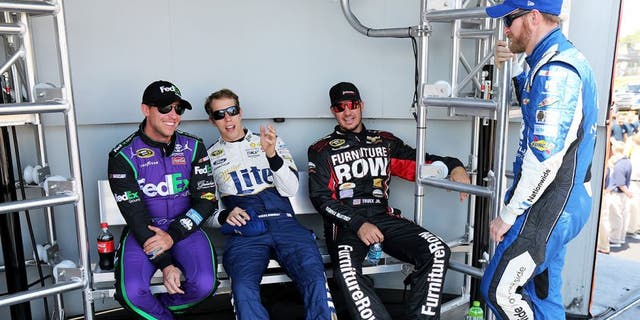 WATKINS GLEN, NY - AUGUST 09: (L-R) Denny Hamlin, driver of the #11 FedEx Ground Toyota, Brad Keselowski, driver of the #2 Miller Lite/Luke Bryan Ford, Martin Truex Jr., driver of the #78 Furniture Row/Visser Precision Chevrolet, and Dale Earnhardt Jr., driver of the #88 Nationwide Chevrolet, talk behind stage prior to the NASCAR Sprint Cup Series Cheez-It 355 at the Glen at Watkins Glen International on August 9, 2015 in Watkins Glen, New York. (Photo by Jerry Markland/Getty Images)