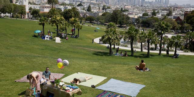 May 28, 2016: A group spreads out blankets for a party at Dolores Park in San Francisco.