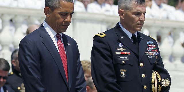 This May 28, 2012 file photo shows President Barack Obama standing with Maj. Gen. Michael S. Linnington, Commander of the U.S. Army Military District of Washington, during a Memorial Day wreath-laying ceremony at the Tomb of the Unknowns at Arlington National Cemetery in Arlington, Va.