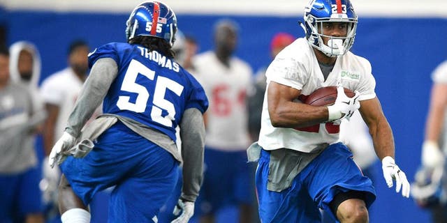 Jun 16, 2015; East Rutherford, NJ, USA; New York Giants running back Rashad Jennings (23) runs the ball during minicamp at Quest Diagnostics Training Center. Mandatory Credit: Steven Ryan-USA TODAY Sports