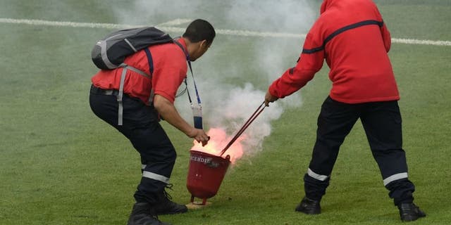 Croatia's midfielder Marcelo Brozovic reacts as firefighter extinguish a flare during the Euro 2016 group D football match between Czech Republic and Croatia at the Geoffroy-Guichard stadium in Saint-Etienne on June 17, 2016. Czech Republic and Croatia drew 2-2. / AFP / JEAN-PHILIPPE KSIAZEK (Photo credit should read JEAN-PHILIPPE KSIAZEK/AFP/Getty Images)