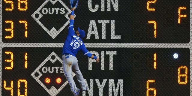 PHILADELPHIA, PA - JUNE 16: Jose Bautista #19 of the Toronto Blue Jays jumps for a fly ball but is unable to make the catch in the seventh inning against the Philadelphia Phillies at Citizens Bank Park on June 16, 2016 in Philadelphia, Pennsylvania. Bautista was injured on the play. (Photo by Drew Hallowell/Getty Images)