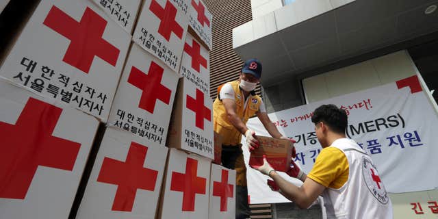 June 18, 2015: Members of South Korean Red Cross unload relief items from a truck for people who are suspected of infection and isolated at their home after having close contact with MERS patients, at Red Cross Emergency Relief Operation Center in Seoul, South Korea.