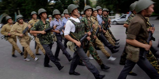 June 17: Kyrgyz police march during the evening guard in the southern Kyrgyz city of Jalal-Abad, Kyrgyzstan.