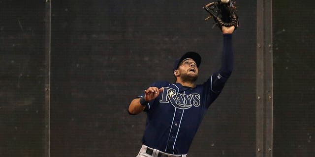 TORONTO, CANADA - APRIL 14: Kevin Kiermaier #39 of the Tampa Bay Rays makes a catch against the wall in the ninth inning during MLB game action against the Toronto Blue Jays on April 14, 2015 at Rogers Centre in Toronto, Ontario, Canada. (Photo by Tom Szczerbowski/Getty Images)