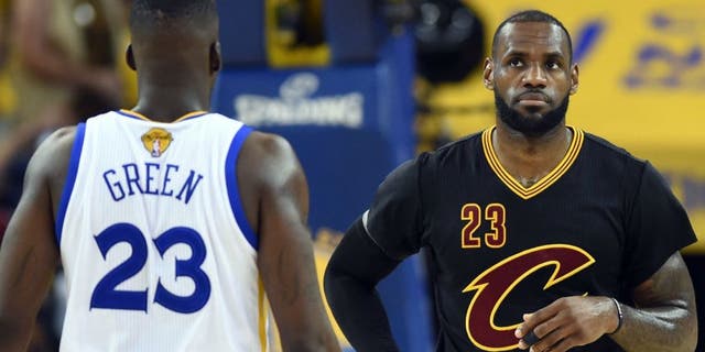 Jun 19, 2016; Oakland, CA, USA; Cleveland Cavaliers forward LeBron James (23) and Golden State Warriors forward Draymond Green (23) during the first quarter in game seven of the NBA Finals at Oracle Arena. Mandatory Credit: Bob Donnan-USA TODAY Sports