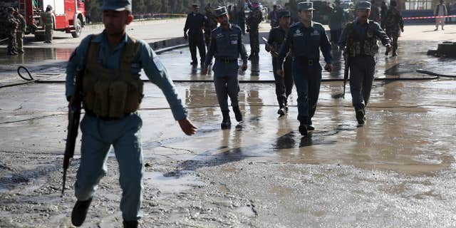 June 20, 2016: Afghan police soldiers inspect the site of a suicide attack in Kabul, Afghanistan.