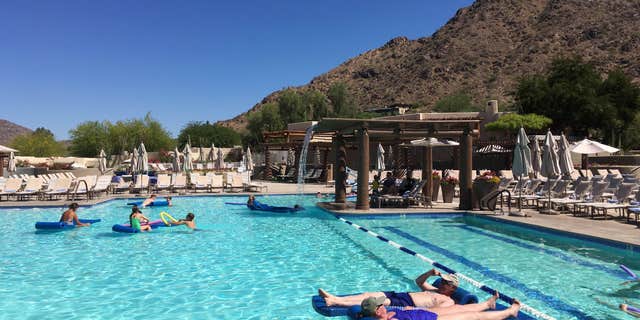 June 19, 2016: Hotel guests cool off at the pool at the JW Marriott Scottsdale Camelback Inn Resort and Spa in Paradise Valley, Ariz.