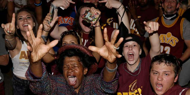 Cleveland Cavaliers fans celebrate after the Cavaliers defeated the Golden State Warriors 93-89 in Game 7 of the NBA basketball Finals, Sunday, June 19, 2016, in Cleveland.