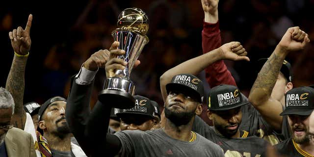 June 19, 2016: Cleveland Cavaliers forward LeBron James, center, celebrates with teammates after Game 7 of basketball's NBA Finals against the Golden State Warriors in Oakland, Calif.
