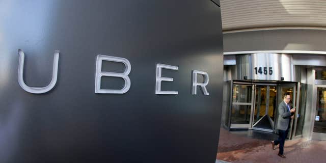 Dec. 16, 2014: A man leaves the headquarters of Uber in San Francisco.