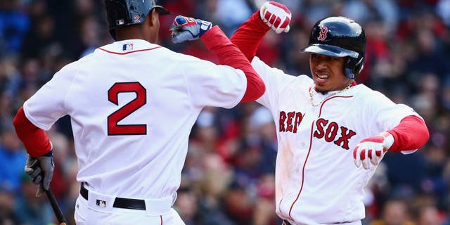 BOSTON, MASSACHUSETTS - APRIL 11: Mookie Betts #50 of the Boston Red Sox celebrates with Xander Bogaerts #2 of the Boston Red Sox after hitting a home run during the ninth inning of the Red Sox home opener at Fenway Park on April 11, 2016 in Boston, Massachusetts. The Orioles defeat the Red Sox 9-7. (Photo by Maddie Meyer/Getty Images)