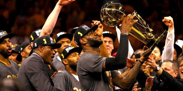 OAKLAND, CA - JUNE 19: LeBron James #23 of the Cleveland Cavaliers holds the Larry O'Brien Championship Trophy after defeating the Golden State Warriors 93-89 in Game 7 of the 2016 NBA Finals at ORACLE Arena on June 19, 2016 in Oakland, California. NOTE TO USER: User expressly acknowledges and agrees that, by downloading and or using this photograph, User is consenting to the terms and conditions of the Getty Images License Agreement. (Photo by Ezra Shaw/Getty Images)