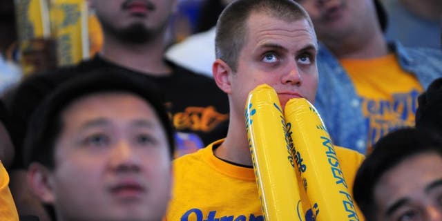 OAKLAND, CA - JUNE 16: A fan reacts in the final moments of Game Six during the Golden State Warriors NBA Finals watch party at ORACLE Arena on June 16, 2016 in Oakland, California. (Photo by Robert Reiners/Getty Images)