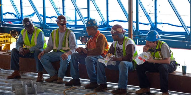 June 18: Construction workers take a lunch break inside the rising structure of One World Trade Center in New York. A Subway sandwich shop is serving workers atop the Ground Zero scaffolding that will become Freedom Tower. The eatery, built out of shipping containers, is rising along with the signature skyscraper with the help of a hydraulically powered platform.