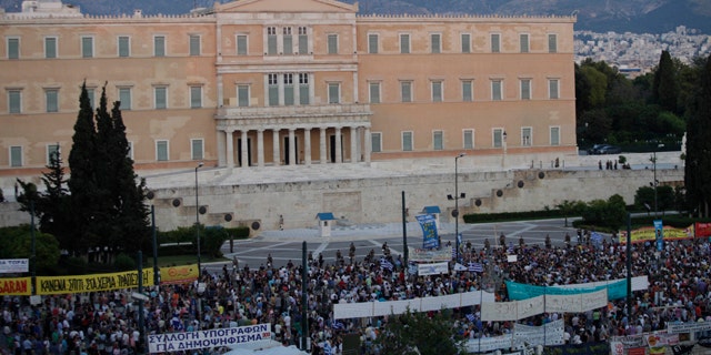 June 21: Greek protesters gather at Syntagma square in front of the Greek Parliament in central Athens, during a peaceful ongoing rally against plans for new austerity measures.