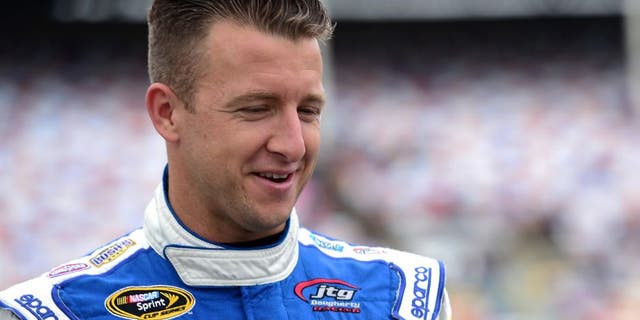 CHARLOTTE, NC - MAY 21: AJ Allmendinger, driver of the #47 Uwharrie Bank Chevrolet, walks on the grid during the NASCAR Sprint Cup Series Sprint Showdown at Charlotte Motor Speedway on May 21, 2016 in Charlotte, North Carolina. (Photo by Jared C. Tilton/Getty Images)