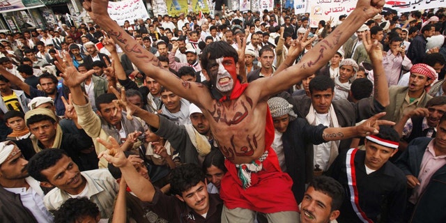 June 21: Anti-government protesters shout slogans during a demonstration to demand the ouster of Yemen's President Ali Abdullah Saleh in Sanaa.