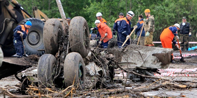June 21: Emergency workers and investigators search wreckage of Tu-134 plane, belonging to the RusAir airline, near the city of Petrozavodsk.