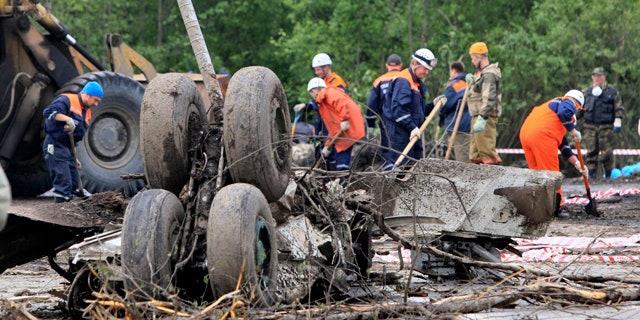 June 21: Emergency workers and investigators search wreckage of Tu-134 plane, belonging to the RusAir airline, near the city of Petrozavodsk.