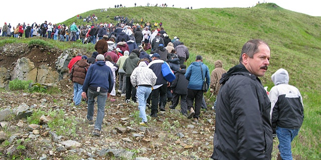 June 23: Fish processing workers and local residents head up the hill after a tsunami warning was issued in Unalaska's Dutch Harbor, in Alaska's Aleutian Islands.