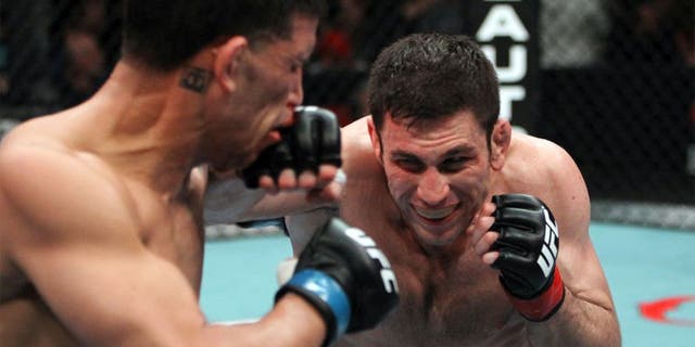 SEATTLE - MARCH 26: (R-L) Amir Sadollah punches DaMarques Johnson during their welterweight bout at the UFC Fight Night 24 event at Key Arena on March 26, 2011 in Seattle, Washington. (Photo by Josh Hedges/Zuffa LLC/Zuffa LLC via Getty Images) *** Local Caption *** Amir Sadollah;DaMarques Johnson