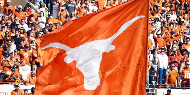 Nov 10, 2012; Austin, TX, USA; Texas Longhorns cheerleaders wave a flag after a touchdown against the Iowa State Cyclones in the first quarter at Darrell K Royal-Texas Memorial Stadium. Mandatory Credit: Brett Davis-USA TODAY Sports