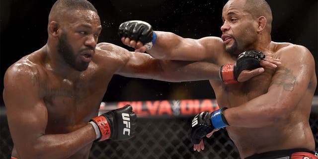 LAS VEGAS, NV - JANUARY 03: Jon Jones (L) and Daniel Cormier (R) exchange punches in their UFC light heavyweight championship bout during the UFC 182 event at the MGM Grand Garden Arena on January 3, 2015 in Las Vegas, Nevada. (Photo by Jeff Bottari/Zuffa LLC/Zuffa LLC via Getty Images)