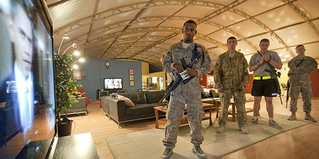 June 23: Spc. Gavin Fruge, 22, of Crowley, La., left, watches a rebroadcast of President Obama's speech on proposed troop withdrawal with fellow soldiers at Kandahar Airfield in Kandahar, Afghanistan.