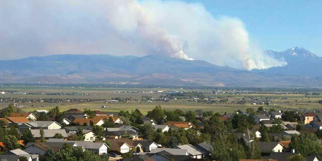 June 22, 2015: Smoke from the Washington Fire rises over the mountains in Markleeville, Calif.